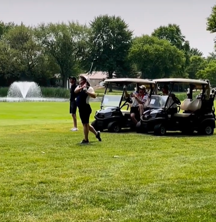 People playing golf on a golf course